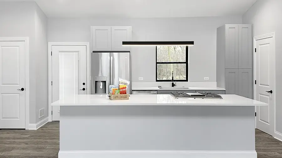 Remodeled kitchen with island and pendant lighting by Skycrest Homes