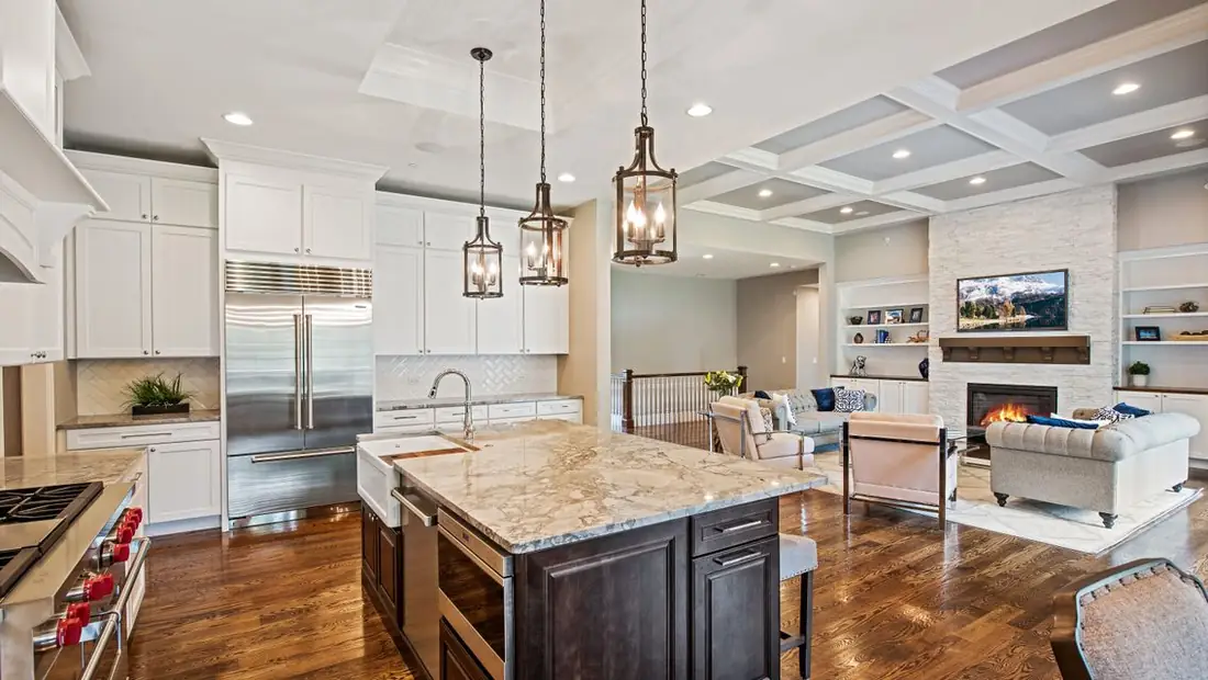 Kitchen with granite island and lantern pendants in a Skycrest custom home