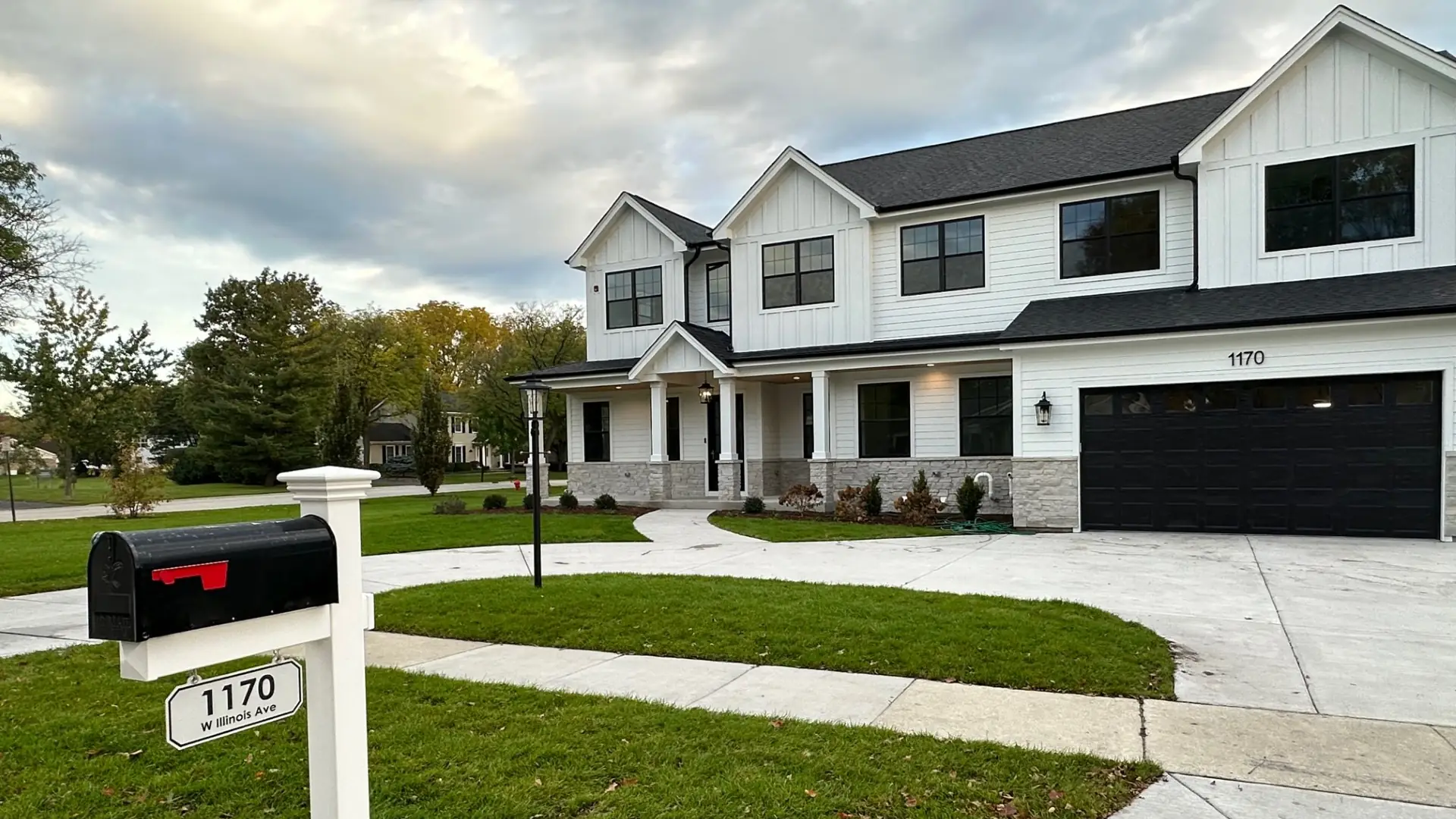 White custom home with a black garage door built by Skycrest Homes