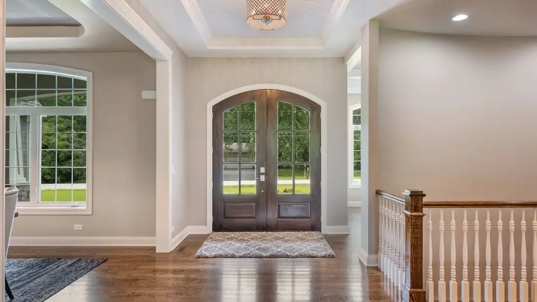 Front foyer with arched double doors in a Skycrest custom home