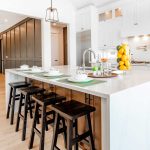 Bright kitchen with white cabinetry and black stools, illustrating a contemporary design concept for Hinsdale home renovations