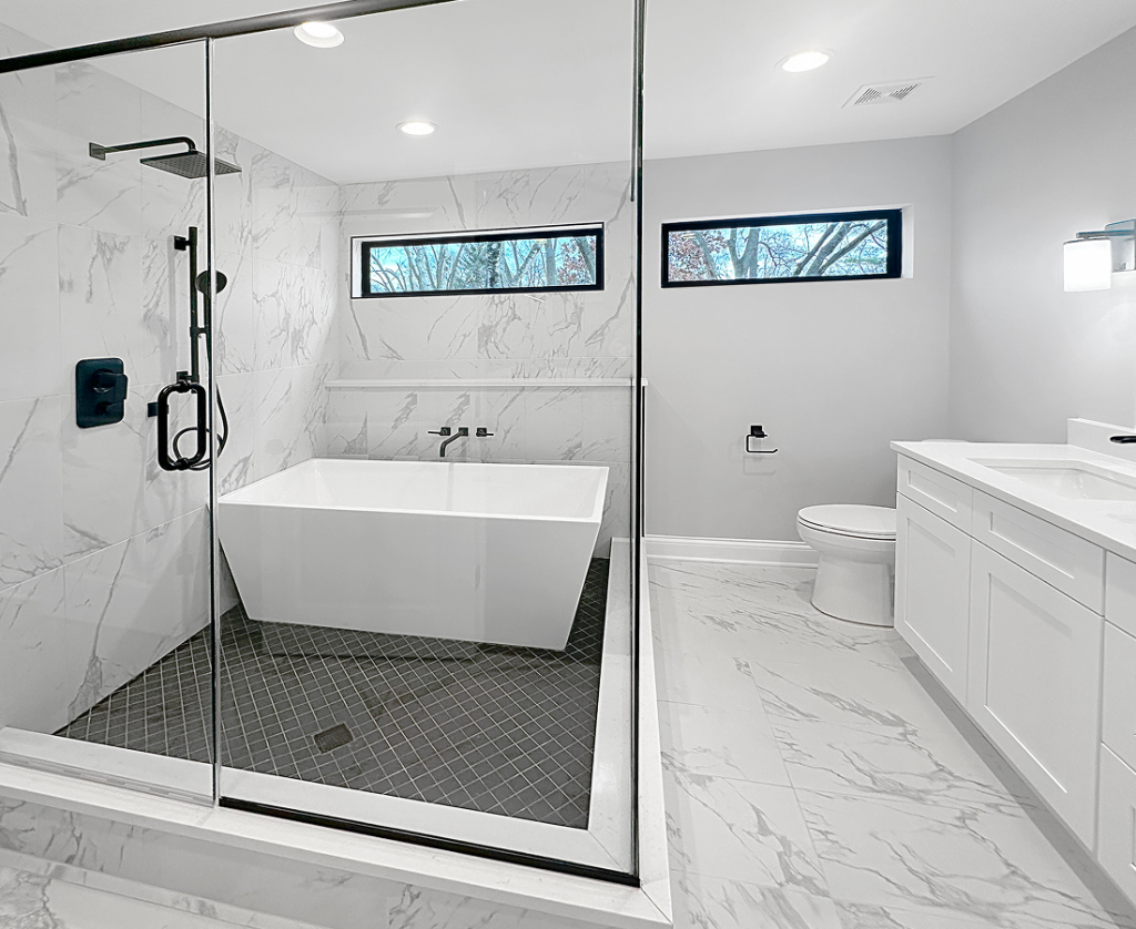 Modern white bathroom by Chicagoland custom home building specialists, featuring dual windows and a large vanity