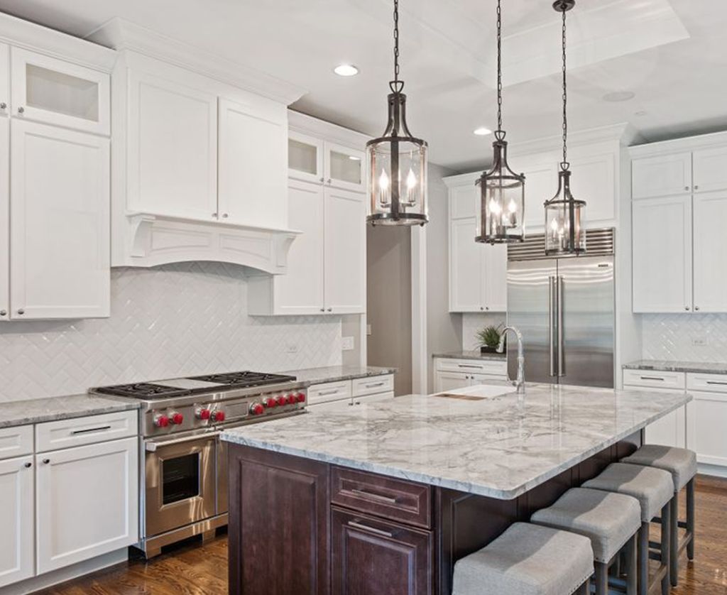 High-end custom kitchen with a dark island and Wolf range in a Chicagoland home
