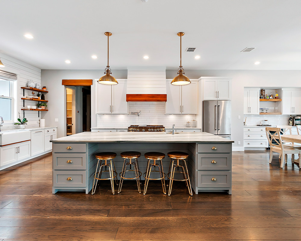 Bright kitchen with white cabinetry and warm wooden floors, reflecting current remodeling trends in Barrington.