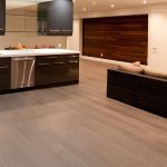 Contemporary basement design with a couch and fireplace, illustrating a comfortable area for a basement renovation project.