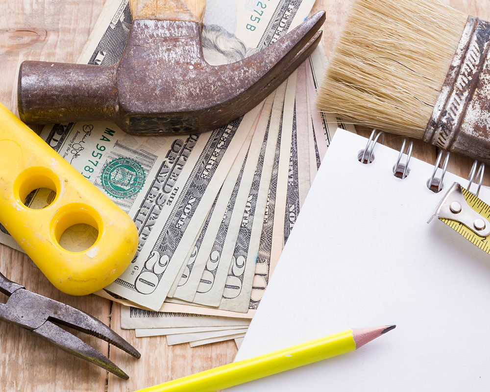 An assortment of tools and supplies arranged on a wooden table, ideal for planning a basement remodel.