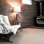 A small, inviting room with a fireplace and a chair, perfect for winter-proofing your basement in Chicagoland.