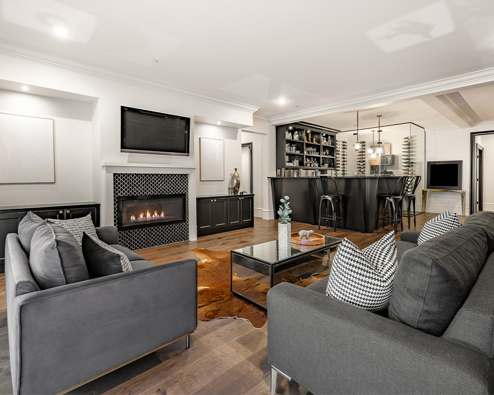 Inviting living room with a fireplace and couch, perfect for discussing winter-proofing your basement.
